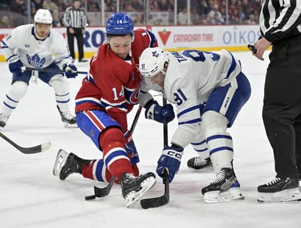 Mar 9, 2024; Montreal, Quebec, CAN: Montreal Canadiens forward Nick Suzuki (14) wins a faceoff against Toronto Maple Leafs forward John Tavares (91) during the first period at the Bell Centre. Mandatory Credit: Eric Bolte-USA TODAY Sports