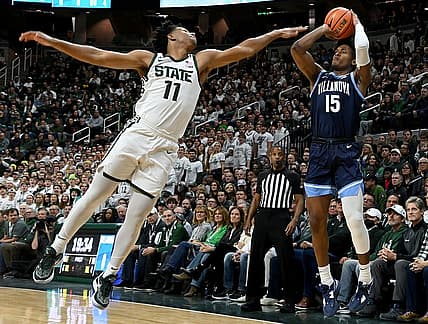 Nov 18, 2022; East Lansing, Michigan, USA;  Villanova Wildcats guard Jordan Longino (15) shoots past Michigan State Spartans guard A.J. Hoggard (11) at Jack Breslin Student Events Center. Mandatory Credit: Dale Young-USA TODAY Sports