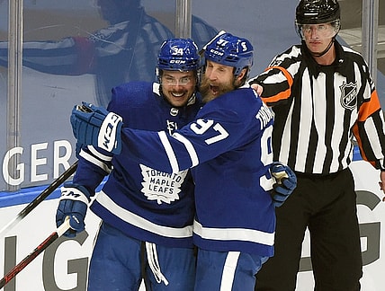 Feb 18, 2021; Toronto, Ontario, CAN;  Toronto Maple Leafs forward Auston Matthews (34) is greeted by forward Joe Thornton (97) after scoring against Ottawa Senators in the first period at Scotiabank Arena. Mandatory Credit: Dan Hamilton-USA TODAY Sports