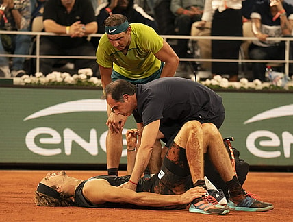 June 3, 2022; Paris, France; Alexander Zverev (GER) falls during his semifinal match against Rafael Nadal (ESP) and has to retire from the match on day 13 of the French Open at Stade Roland-Garros. He was taken from the court in a wheelchair and came back out with crutches to officially retire from the match. Mandatory Credit: Susan Mullane-USA TODAY Sports