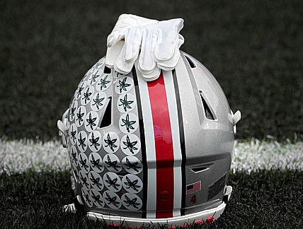 Oct. 14, 2023; Lafayette, In., USA; 
Gloves lie on top of the helmet of Ohio State Buckeyes wide receiver Julian Fleming (4) before Saturday's NCAA Division I football game against the Purdue Boilermakers at Ross-Ade Stadium in Lafayette.