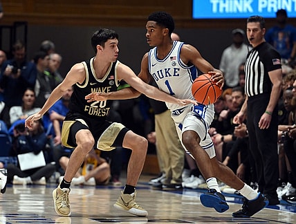 Feb 12, 2024; Durham, North Carolina, USA;  Duke Blue Devils guard Caleb Foster (1) controls the ball in front of Wake Forest Deamon Deacons guard Parker Friedrichsen (20) during the first half at Cameron Indoor Stadium. Mandatory Credit: Rob Kinnan-USA TODAY Sports