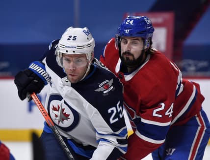 Mar 6, 2021; Montreal, Quebec, CAN; Winnipeg Jets forward Paul Stasny (25) and Montreal Canadiens forward Phillip Danault (24) battle for position during the first period at the Bell Centre. Mandatory Credit: Eric Bolte-USA TODAY Sports