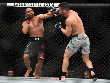 Mar 3, 2018; Las Vegas, NV, USA; John Dodson lands a hit against Pedro Munhoz during UFC 222 at T-Mobile Arena. Mandatory Credit: Stephen R. Sylvanie-USA TODAY Sports