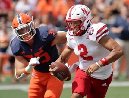 Aug 28, 2021; Champaign, Illinois, USA;  Nebraska Cornhuskers quarterback is pursued by Illinois fighting Illini linebacker Jake Hansen (35) during the first half at Memorial Stadium. Mandatory Credit: Ron Johnson-USA TODAY Sports