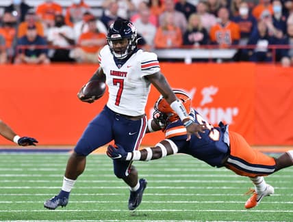 Sep 24, 2021; Syracuse, New York, USA; Liberty Flames quarterback Malik Willis (7) escapes a tackle by Syracuse Orange linebacker Mikel Jones (3) in the first quarter at the Carrier Dome. Mandatory Credit: Mark Konezny-USA TODAY Sports