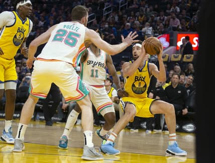 Mar 20, 2022; San Francisco, California, USA; Golden State Warriors guard Klay Thompson (11) pulls up for a shot against San Antonio Spurs center Jakob Poeltl (25) and Joshua Primo (11) during the third quarter at Chase Center. Mandatory Credit: D. Ross Cameron-USA TODAY Sports