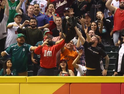 Mar 14, 2023; Phoenix, Arizona, USA; A Mexico fan in the crowd catches a ball with an oversized glove in the fourth inning against Great Britain during the World Baseball Classic at Chase Field. Mandatory Credit: Mark J. Rebilas-USA TODAY Sports