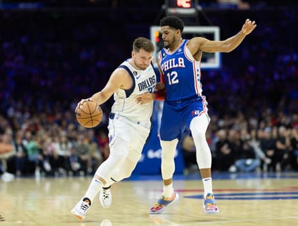 Mar 29, 2023; Philadelphia, Pennsylvania, USA; Dallas Mavericks guard Luka Doncic (77) dribbles the ball against Philadelphia 76ers forward Tobias Harris (12) during the first quarter at Wells Fargo Center. Mandatory Credit: Bill Streicher-USA TODAY Sports