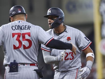 May 29, 2023; Houston, Texas, USA; Minnesota Twins third baseman Royce Lewis (23) reacts with first base/catching coach Hank Conger (35) after driving in a run with a single during the ninth inning against the Houston Astros at Minute Maid Park. Mandatory Credit: Troy Taormina-USA TODAY Sports