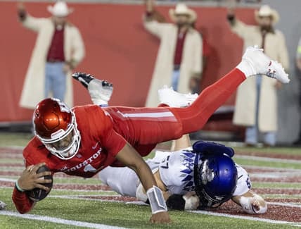Sep 16, 2023; Houston, Texas, USA; Houston Cougars wide receiver Samuel Brown (4) is tackled by TCU Horned Frogs linebacker Johnny Hodges (57) on the one yard line in the second half at TDECU Stadium. Mandatory Credit: Thomas Shea-USA TODAY Sports