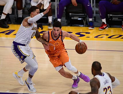 May 30, 2021; Los Angeles, California, USA; Phoenix Suns guard Devin Booker (1) moves the ball against Los Angeles Lakers forward Kyle Kuzma (0) during the first half in game four of the first round of the 2021 NBA Playoffs. at Staples Center. Mandatory Credit: Gary A. Vasquez-USA TODAY Sports