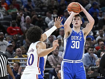Nov 15, 2022; Indianapolis, Indiana, USA;  Duke Blue Devils center Kyle Filipowski (30) shoots the ball over Kansas Jayhawks forward Jalen Wilson (10) during the first half at Gainbridge Fieldhouse. Mandatory Credit: Marc Lebryk-USA TODAY Sports