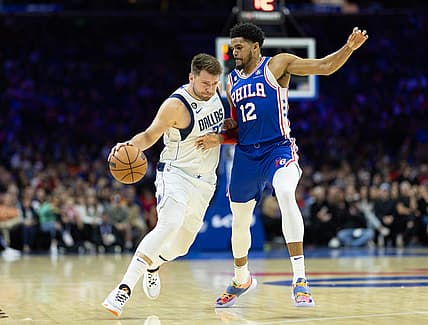 Mar 29, 2023; Philadelphia, Pennsylvania, USA; Dallas Mavericks guard Luka Doncic (77) dribbles the ball against Philadelphia 76ers forward Tobias Harris (12) during the first quarter at Wells Fargo Center. Mandatory Credit: Bill Streicher-USA TODAY Sports