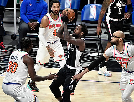 May 9, 2021; Los Angeles, California, USA; LA Clippers guard Patrick Beverley (21) drives to the basket between New York Knicks forward Julius Randle (30), guard Derrick Rose (4) and center Taj Gibson (67) during the first quarter at Staples Center. Mandatory Credit: Robert Hanashiro-USA TODAY Sports