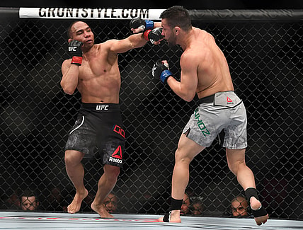 Mar 3, 2018; Las Vegas, NV, USA; John Dodson lands a hit against Pedro Munhoz during UFC 222 at T-Mobile Arena. Mandatory Credit: Stephen R. Sylvanie-USA TODAY Sports