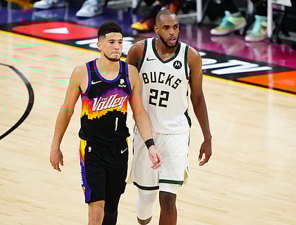 Jul 6, 2021; Phoenix, Arizona, USA; Phoenix Suns guard Devin Booker (1) alongside Milwaukee Bucks forward Khris Middleton (22) during the second half in game one of the 2021NBA Finals at Phoenix Suns Arena. Mandatory Credit: Mark J. Rebilas-USA TODAY Sports