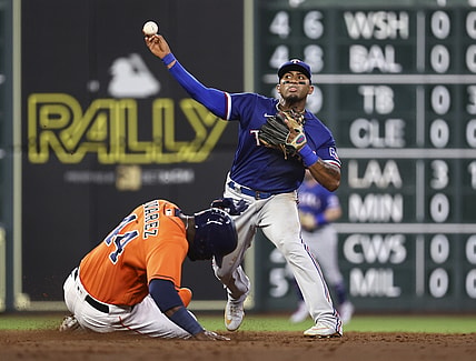 Jul 23, 2021; Houston, Texas, USA; Houston Astros designated hitter Yordan Alvarez (44) is out at second base as Texas Rangers second baseman Andy Ibanez (77) throws to first base during the third inning at Minute Maid Park. Mandatory Credit: Troy Taormina-USA TODAY Sports