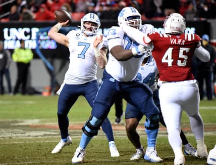 Nov 26, 2021; Raleigh, North Carolina, USA;  North Carolina Tar Heels quarterback Sam Howell (7) throws a pass during the second half against the North Carolina State Wolfpack at Carter-Finley Stadium.  The Wolfpack won 34-30. Mandatory Credit: Rob Kinnan-USA TODAY Sports