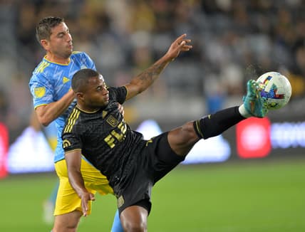 May 7, 2022; Los Angeles, California, USA;  Philadelphia Union midfielder Alejandro Bedoya (11) and Los Angeles FC defender Diego Palacios (12) go for the ball in the first half at Banc of California Stadium. Mandatory Credit: Jayne Kamin-Oncea-USA TODAY Sports