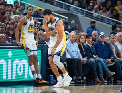 Dec 14, 2022; Indianapolis, Indiana, USA; Golden State Warriors guard Stephen Curry (30) grabs his shoulder in the second half against the Indiana Pacers at Gainbridge Fieldhouse. Mandatory Credit: Trevor Ruszkowski-USA TODAY Sports