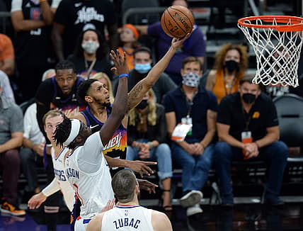 Jun 22, 2021; Phoenix, Arizona, USA; Phoenix Suns forward Mikal Bridges (25) shoots over LA Clippers guard Reggie Jackson (1) during the second half of game two of the Western Conference Finals for the 2021 NBA Playoffs at Phoenix Suns Arena. Mandatory Credit: Joe Camporeale-USA TODAY Sports