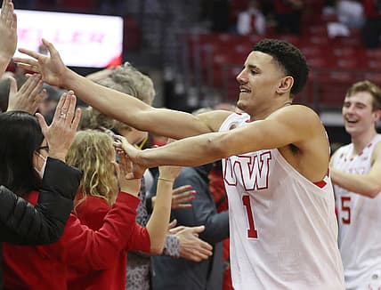 Feb 20, 2022; Madison, Wisconsin, USA; Wisconsin Badgers guard Johnny Davis (1) greets the fans after the victory defeating the Michigan Wolverines at the Kohl Center. Mandatory Credit: Mary Langenfeld-USA TODAY Sports