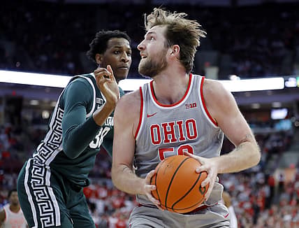 Mar 3, 2022; Columbus, Ohio, USA; Ohio State Buckeyes center Joey Brunk (50) controls the ball as Michigan State Spartans forward Marcus Bingham Jr. (30) defends during the second half at Value City Arena. Mandatory Credit: Joseph Maiorana-USA TODAY Sports