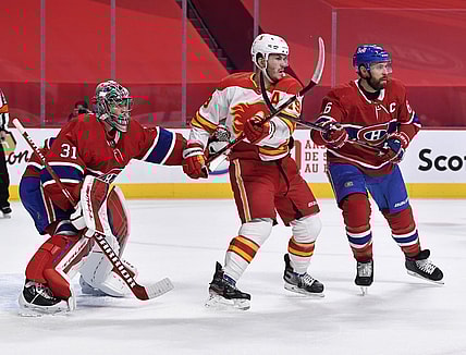 Jan 28, 2021; Montreal, Quebec, CAN; Montreal Canadiens goalie Carey Price (31) and teammate Shea Weber (6) deal with Calgary Flames forward Matthew Tkachuk (19) in front of the net during the first period at the Bell Centre. Mandatory Credit: Eric Bolte-USA TODAY Sports