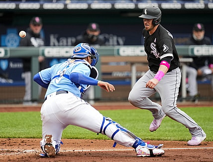 May 9, 2021; Kansas City, Missouri, USA; Chicago White Sox catcher Yasmani Grandal (R) scores a run as Kansas City Royals catcher Salvador Perez (L) is unable to make the catch during the third inning at Kauffman Stadium. Mandatory Credit: Jay Biggerstaff-USA TODAY Sports