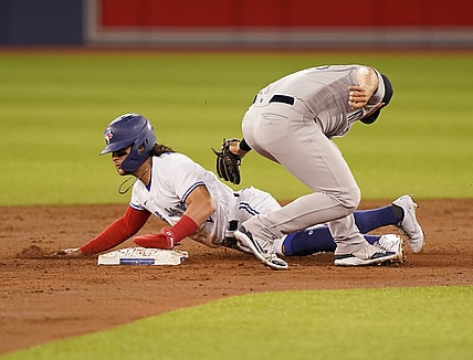 Sep 28, 2021; Toronto, Ontario, CAN; Toronto Blue Jays shortstop Bo Bichette (11) steals second base against New York Yankees second baseman Gleyber Torres (25) during the first inning at Rogers Centre. Mandatory Credit: John E. Sokolowski-USA TODAY Sports