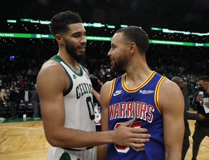 Dec 17, 2021; Boston, Massachusetts, USA; Boston Celtics forward Jayson Tatum (0) talks with Golden State Warriors guard Stephen Curry (30) after their game at TD Garden. Mandatory Credit: Winslow Townson-USA TODAY Sports