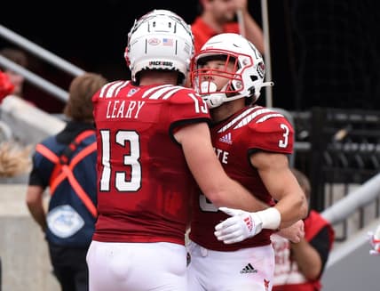 Sep 10, 2022; Raleigh, North Carolina, USA;North Carolina State Wolfpack running back Jordan Houston (3) celebrates his touchdown catch with quarterback Devon Leary (13) during the first half against the Charleston Southern Buccaneers at Carter-Finley Stadium. Mandatory Credit: Rob Kinnan-USA TODAY Sports