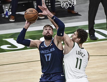 Apr 17, 2021; Milwaukee, Wisconsin, USA; Memphis Grizzlies center Jonas Valanciunas (17) takes a shot against Milwaukee Bucks center Brook Lopez (11) in the third quarter at Fiserv Forum. Mandatory Credit: Benny Sieu-USA TODAY Sports
