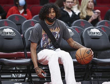 Nov 27, 2021; Houston, Texas, USA; Houston Rockets guard Jalen Green (0) dribbles a ball while sitting in the bench area before the game against the Charlotte Hornets at Toyota Center. Mandatory Credit: Troy Taormina-USA TODAY Sports