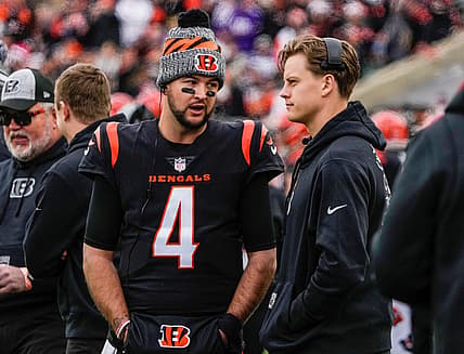 Cincinnati Bengals quarterbacks AJ McCarron (4) and Joe Burrow (9) talk as the Bengals take on Minnesota Vikings at Paycor Stadium Saturday, December 16, 2023.