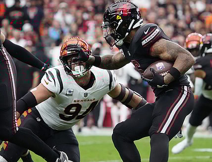 Oct 8, 2023; Glendale, Arizona, United States; Arizona Cardinals running back James Conner (6) stiff arms Cincinnati Bengals defensive end Sam Hubbard (94) at State Farm Stadium. Mandatory Credit: Joe Rondone-USA TODAY Sports