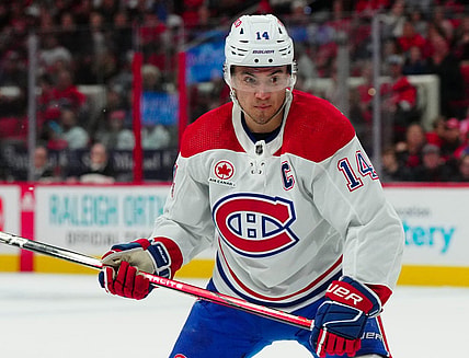 Dec 28, 2023; Raleigh, North Carolina, USA; Montreal Canadiens center Nick Suzuki (14) watches the play against the Carolina Hurricanes during the second period at PNC Arena. Mandatory Credit: James Guillory-USA TODAY Sports