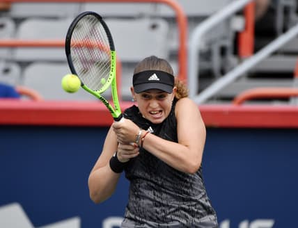Aug 9, 2021; Montreal, Quebec, Canada; Jelena Ostapenko of Latvia hits a shot against Katerina Siniakova of the Czech Republic (not pictured) during first round play at Stade IGA. Mandatory Credit: Eric Bolte-USA TODAY Sports