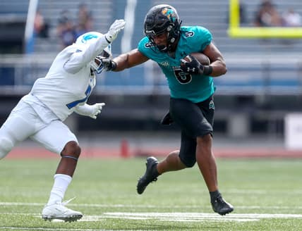 Sep 18, 2021; Buffalo, New York, USA; Coastal Carolina Chanticleers wide receiver Aaron Bedgood (3) stiff arms Buffalo Bulls safety E.J. Brown (7) during the second quarter of play at UB Stadium. Mandatory Credit: Nicholas LoVerde-USA TODAY Sports