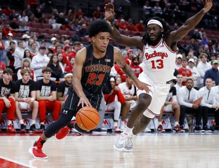 Feb 2, 2023; Columbus, Ohio, USA;  Wisconsin Badgers guard Chucky Hepburn (23) dribbles past Ohio State Buckeyes guard Isaac Likekele (13) who is defending on the play during the first half at Value City Arena. Mandatory Credit: Joseph Maiorana-USA TODAY Sports