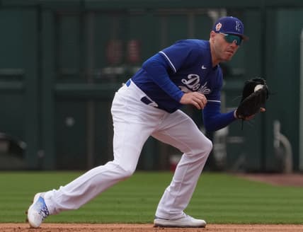 Mar 19, 2023; Phoenix, Arizona, USA; Los Angeles Dodgers first baseman Freddie Freeman (5) fields a ground ball against the Oakland Athletics during the third inning at Camelback Ranch-Glendale. Mandatory Credit: Joe Camporeale-USA TODAY Sports