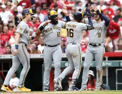 Jun 3, 2023; Cincinnati, Ohio, USA; Milwaukee Brewers right fielder Blake Perkins (16) reacts with center fielder Joey Wiemer (28), first baseman Jon Singleton (12), and  third baseman Brian Anderson (9) after hitting a grand slam against the Cincinnati Reds during the third inning at Great American Ball Park. Mandatory Credit: David Kohl-USA TODAY Sports