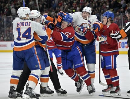 Jan 25, 2024; Montreal, Quebec, CAN; Montreal Canadiens forward Juraj Slafkovsky (20) exchanges blows with New York Islanders defenseman Alexander Romanov (28) during the first period at the Bell Centre. Mandatory Credit: Eric Bolte-USA TODAY Sports