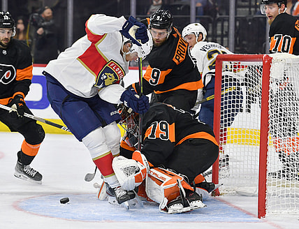 Oct 23, 2021; Philadelphia, Pennsylvania, USA;  Philadelphia Flyers goaltender Carter Hart (79) and  defenseman Ivan Provorov (9) hold off Florida Panthers center Eetu Luostarinen (27) during the second period at Wells Fargo Center. Mandatory Credit: Eric Hartline-USA TODAY Sports