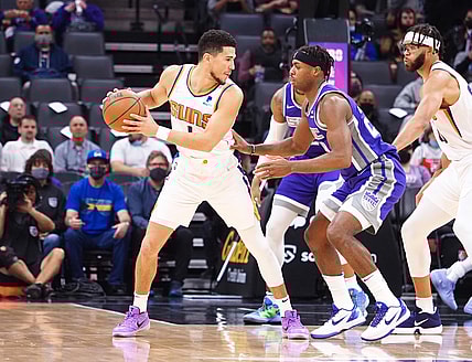 Nov 8, 2021; Sacramento, California, USA; Phoenix Suns guard Devin Booker (1) controls the ball against Sacramento Kings guard Buddy Hield (24) during the order quarter at Golden 1 Center. Mandatory Credit: Kelley L Cox-USA TODAY Sports