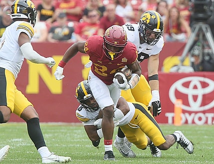 Iowa State Cyclones running back Abu Sama (24) breaks a tackle from Iowa Hawkeyes' defensive back Deshaun Lee (8) and Iowa Hawkeyes defensive line Yahya Black (94) during the second quarter of the Cy-Hawk football game at the Jack Trice Stadium on Saturday, Sept. 9, 2023, in Ames, Iowa.