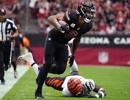 Arizona Cardinals running back James Conner (6) breaks past Cincinnati Bengals safety Nick Scott (33) at State Farm Stadium in Glendale on Oct. 8, 2023.