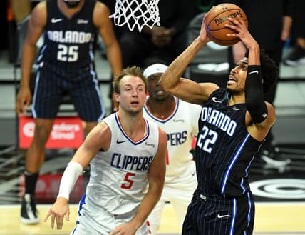 Mar 30, 2021; Los Angeles, California, USA; Orlando Magic forward Otto Porter Jr. (22) goes to the basket as Los Angeles Clippers guard Luke Kennard (5) looks on during the first half at Staples Center. Mandatory Credit: Jayne Kamin-Oncea-USA TODAY Sports