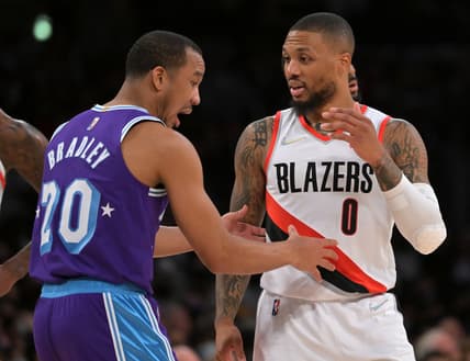 Dec 31, 2021; Los Angeles, California, USA; Portland Trail Blazers guard Damian Lillard (0) and Los Angeles Lakers guard Avery Bradley (20) talk in the first half at Crypto.com Arena. Mandatory Credit: Jayne Kamin-Oncea-USA TODAY Sports